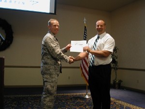 In December, Lt. Col. Mike Anderson, USAF (l), chapter president, presents Riccardo Magni of Pioneer Valley High School with a chapter grant for teachers.